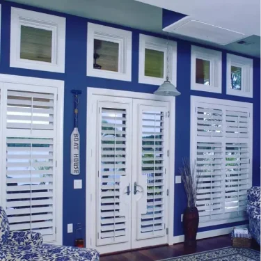 White-Moveable-Louvered-interior-doors-and-windows-in-blue-boat-house